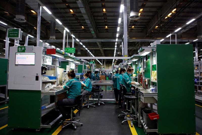 &copy; Reuters. FILE PHOTO: Employees work on the production line during an organised media tour to a Schneider Electric factory in Beijing, China February 17, 2022. REUTERS/Florence Lo