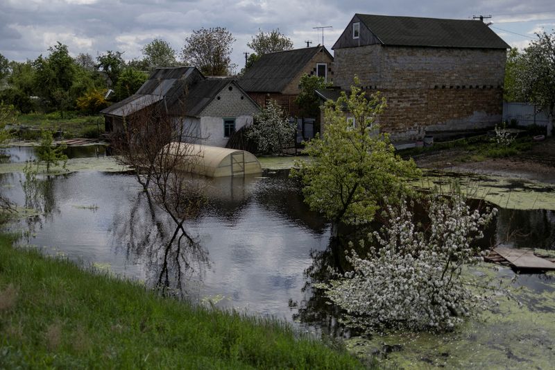 Months after dam destroyed to stop Russian advance, parts of village still flooded