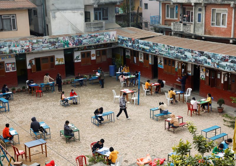 &copy; Reuters. FILE PHOTO: Students maintain social distance as they study inside the compound of a school amid the spread of coronavirus disease (COVID-19) outbreak in Kathmandu, Nepal February 3, 2022. REUTERS/Navesh Chitrakar