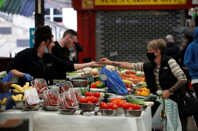 &copy; Reuters. FILE PHOTO: A woman does groceries as restrictions in the city have started to ease, amid the outbreak of the coronavirus disease (COVID-19), at a market in Leicester, Britain, August 19, 2020.  REUTERS/Paul Childs