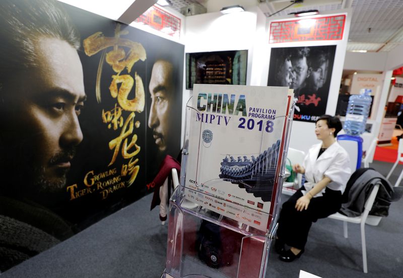 © Reuters. FILE PHOTO: A visitor is seen at a China booth during the MIPTV, the International Television Programs Market, in Cannes, France, April 9, 2018. Picture taken April 9, 2018.  REUTERS/Eric Gaillard