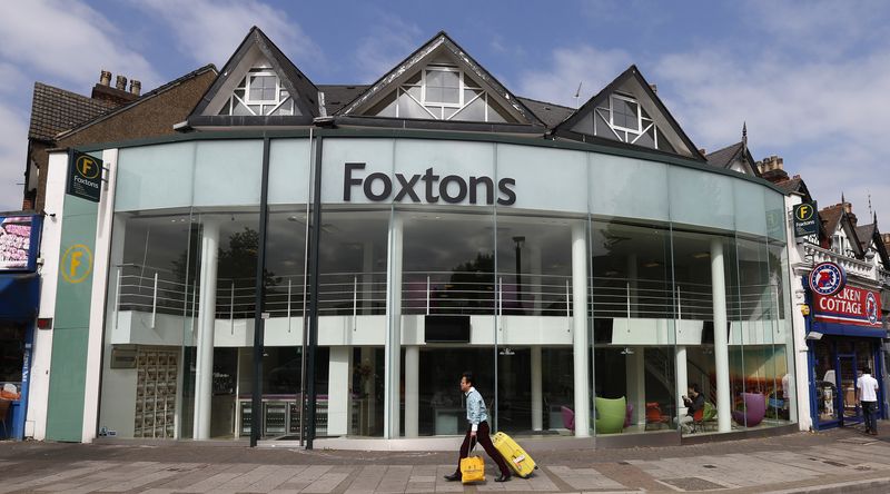 © Reuters. A man pulls a suitcase past a branch of Foxtons estate agent, in north London September 3, 2013. Britain's Foxtons priced its London listing at the top of its range, valuing the estate agent at 649 million pounds ($1 billion) and defying concerns the property market is overheating. Foxtons said on September 20, 2013 it had sold a 60 percent stake for 230 pence per share, the top of its original 190 pence to 230 pence per share range. Photograph taken on September 3, 2013.    REUTERS/Suzanne Plunkett  (BRITAIN - Tags: BUSINESS)