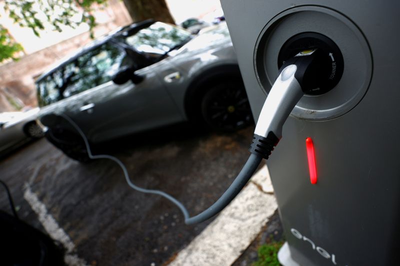 &copy; Reuters. FILE PHOTO: An electric car is seen plugged in at a charging point for electric vehicles in Rome, Italy, April 28, 2021. REUTERS/Guglielmo Mangiapane/File Photo