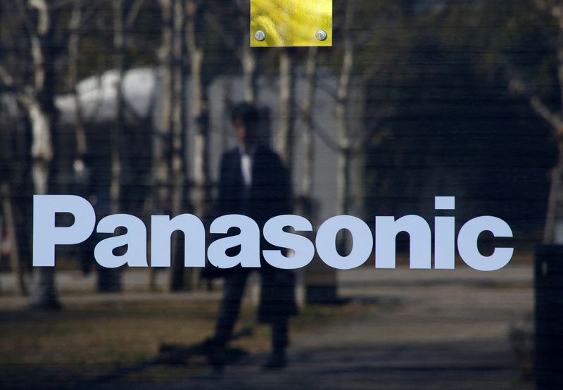 © Reuters. FILE PHOTO: A man is reflected on Panasonic Corp's logo at Panasonic Center in Tokyo, Japan, February 2, 2017.  REUTERS/Kim Kyung-Hoon/File Photo