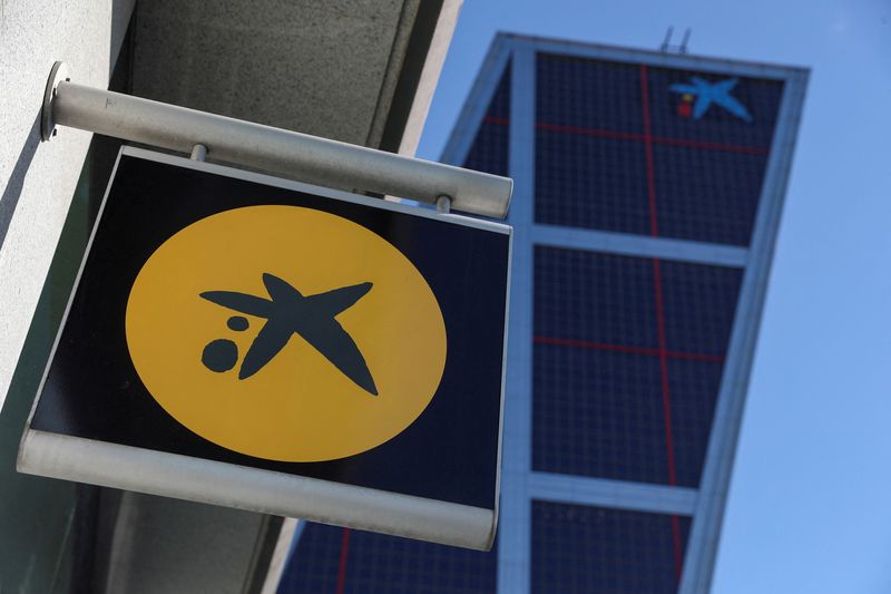 &copy; Reuters. FILE PHOTO: A CaixaBank branch logo is seen next to CaixaBank headquarters in Madrid, Spain May 14, 2021. REUTERS/Susana Vera/File Photo
