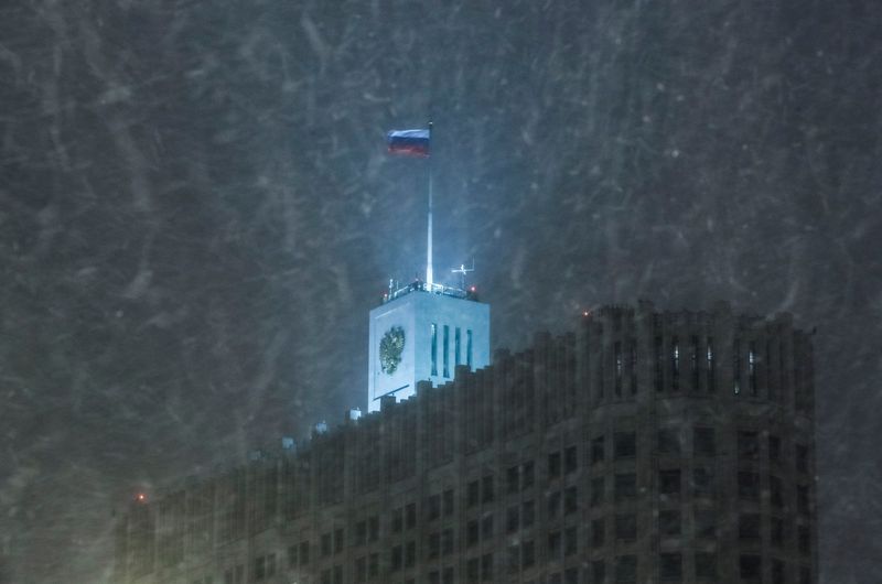 © Reuters. العلم الروسي يرفرف فوق مقر الحكومة الاتحادي فيما تتساقط الثلوج في موسكو بصورة من أرشيف رويترز.
