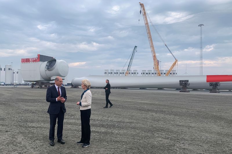&copy; Reuters. El canciller alemán, Olaf Scholz, y la presidenta de la Comisión Europea, Ursula von der Leyen, conversan junto a las piezas de un aerogenerador en el puerto de Esbjerg, Dinamarca, el 18 de mayo de 2022. REUTERS/Stine Jacobsen