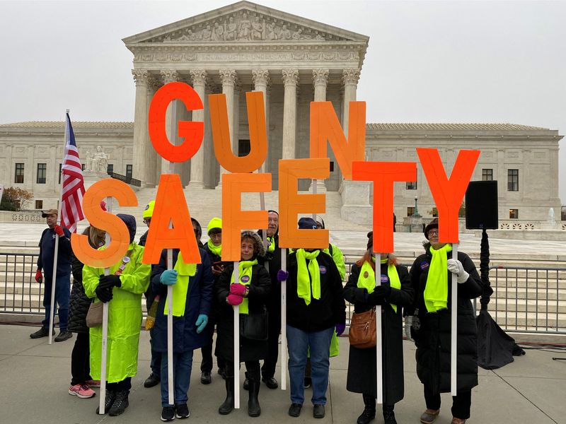 &copy; Reuters. FILE PHOTO: A group among hundreds of supporters of gun control laws rally in front of the US Supreme Court as the justices hear the first major gun rights case since 2010, in Washington, U.S. December 2, 2019. REUTERS/Andrew Chung/File Photo