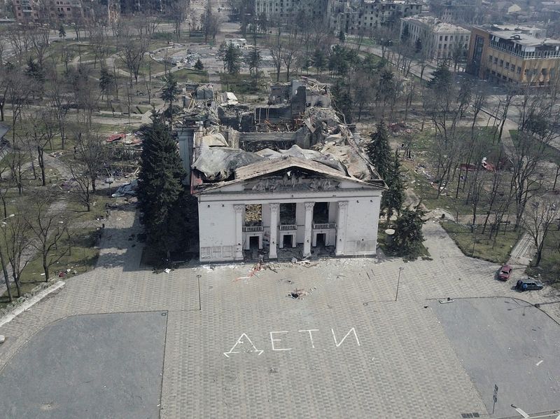 &copy; Reuters. FILE PHOTO: A view shows the building of a theatre destroyed in the course of Ukraine-Russia conflict, as a word "children" in Russian is written in large white letters on the pavement, in the southern port city of Mariupol, Ukraine April 10, 2022.  Pictu