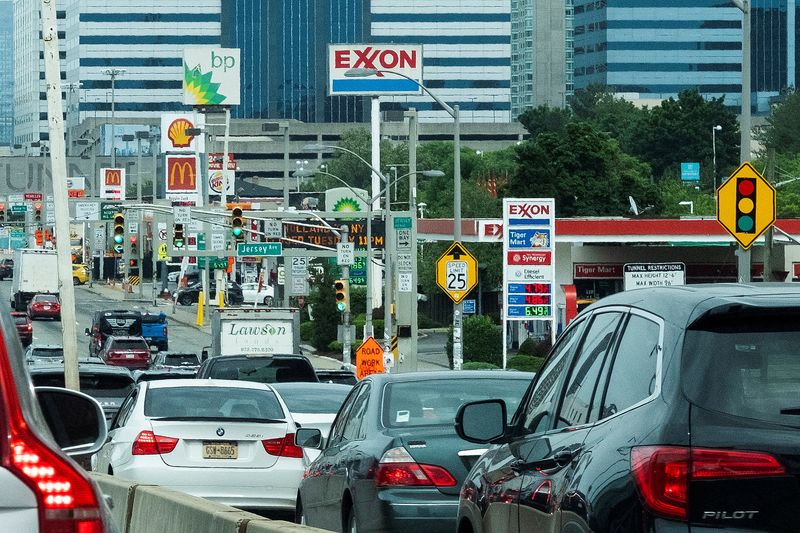 &copy; Reuters. FILE PHOTO: People drive their cars near Exxon and BP gas stations at the exit of the Holland Tunnel during the start of the Memorial Day weekend, under rising gas prices and record inflation, in Newport, New Jersey, U.S., May 27, 2022.  REUTERS/Eduardo M
