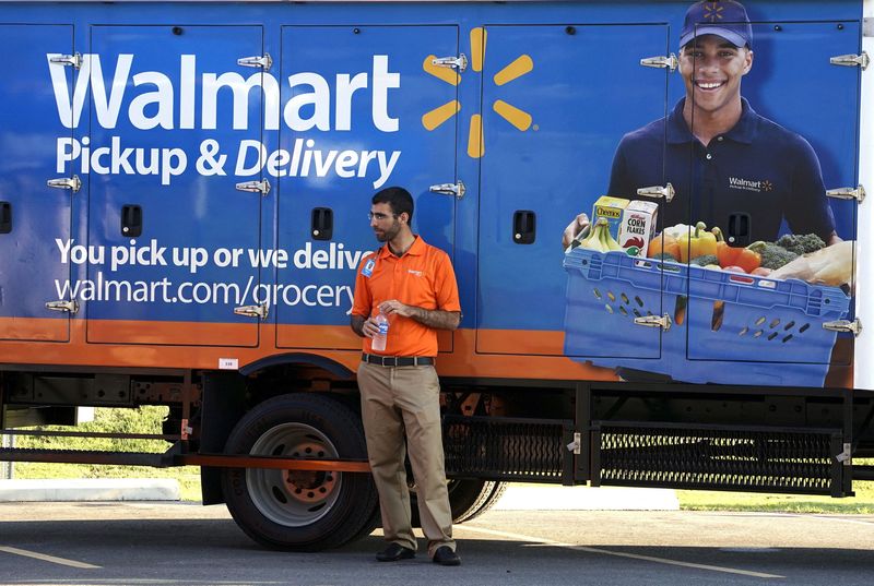 &copy; Reuters. FILE PHOTO: A Wal-Mart Pickup-Grocery employee waits next to a truck at a test store in Bentonville, Arkansas June 4, 2015.   REUTERS/Rick Wilking