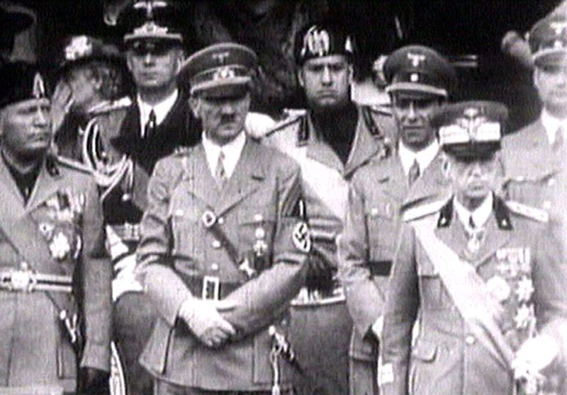 © Reuters. FILE PHOTO: King Victor Emanuel III, Adolf Hitler and Benito Mussolini watch fascist troops march in central Rome in 1941 television file footage. Image via REUTERS