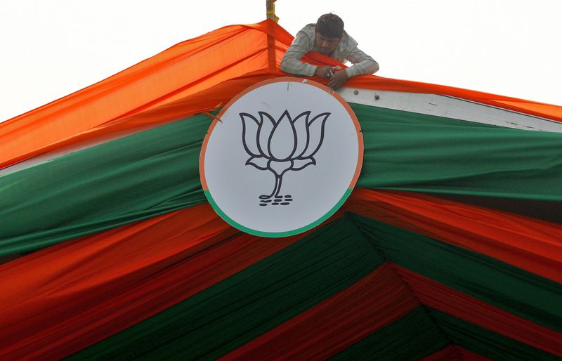 &copy; Reuters. هندي يعمل على تثبيت رمز حزب بهاراتيا جاناتا الحاكم في الهند فوق خيمة خلال حملة انتخابية في براياجراج يوم 24 فبراير شباط 2022. تصوير: ريتيش شوكلا
