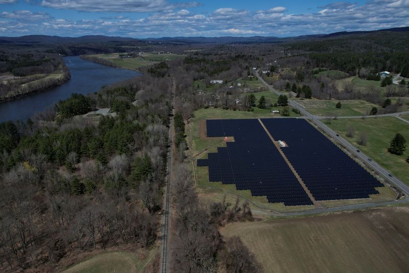 &copy; Reuters. FILE PHOTO: Solar panels are arrayed on Earth Day in Northfield, Massachusetts, U.S., April 22, 2022. Picture taken with a drone. REUTERS/Brian Snyder