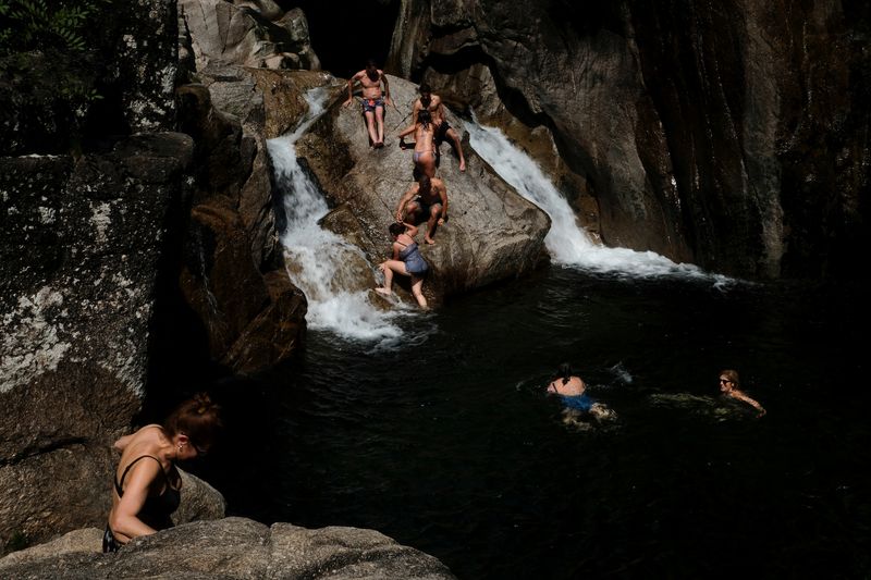 &copy; Reuters. FILE PHOTO: People swim in the Cavado River at the Peneda-Geres National Park near Braga, Portugal May 7, 2022. REUTERS/Darrin Zammit Lupi