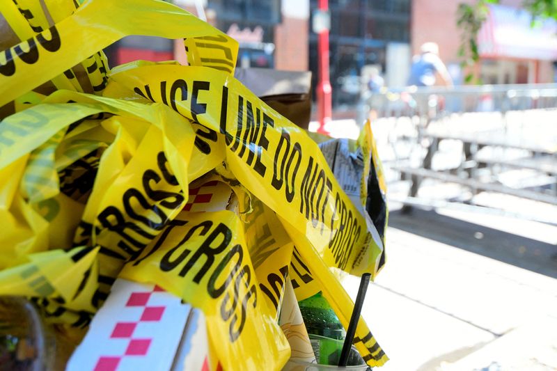 © Reuters. FILE PHOTO: Police tape is pictured at a trash can on the street, at a crime scene after a deadly mass shooting on South Street in Philadelphia, Pennsylvania, U.S., June 5, 2022.  REUTERS/Bastiaan Slabbers/File Photo