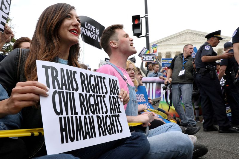 &copy; Reuters. FILE PHOTO: LGBT activists and supporters block the street outside the U.S. Supreme Court as it hears arguments in a major LGBT rights case on whether a federal anti-discrimination law that prohibits workplace discrimination on the basis of sex covers gay