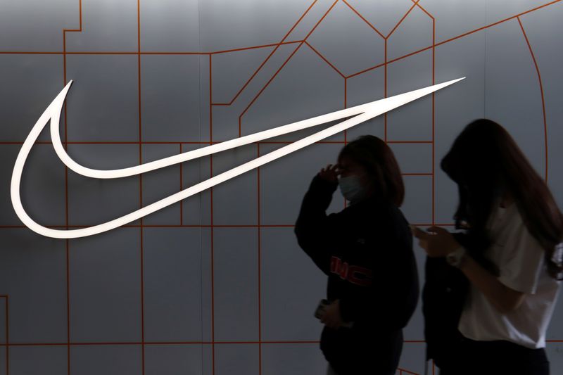 &copy; Reuters. People walk past a store of the sporting goods retailer Nike Inc at a shopping complex in Beijing, China March 25, 2021. REUTERS/Florence Lo