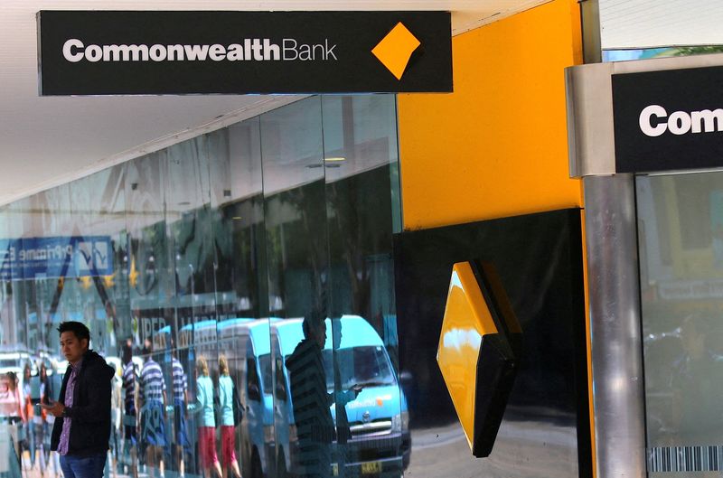 &copy; Reuters. FILE PHOTO: FILE PHOTO: A pedestrian is reflected in the window of a branch of the Commonwealth Bank of Australia (CBA) in Sydney, Australia, November 8, 2017. REUTERS/Steven Saphore/File Photo/File Photo