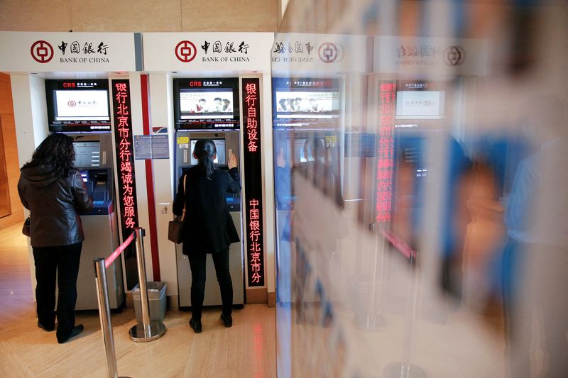 &copy; Reuters. FILE PHOTO: People use ATM's inside the Bank of China head office building in Beijing, China March 30, 2016. REUTERS/Damir Sagolj