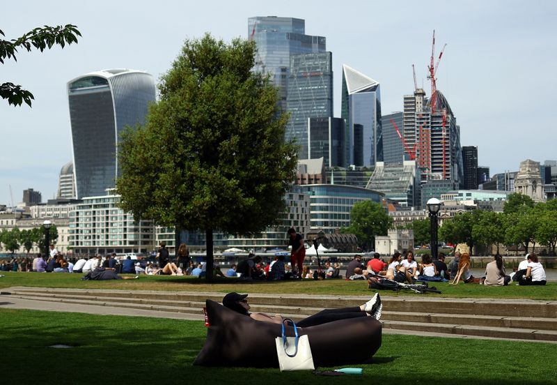 &copy; Reuters. A woman sunbathes in front of the city of London financial district in London, Britain, May 18, 2022. REUTERS/Hannah McKay