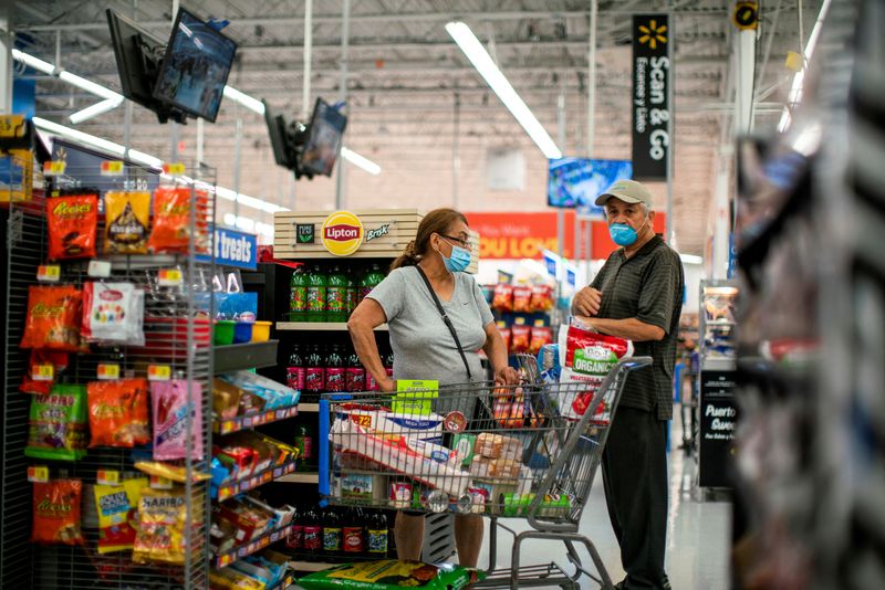 &copy; Reuters. FILE PHOTO: Shoppers are seen wearing masks while shopping at a Walmart store, in North Brunswick, New Jersey, U.S. July 20, 2020. REUTERS/Eduardo Munoz