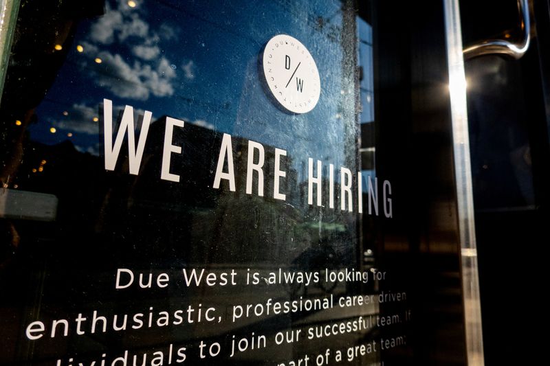 © Reuters. A help wanted sign at a store along Queen Street West in Toronto Ontario, Canada June 10, 2022. REUTERS/Carlos Osorio