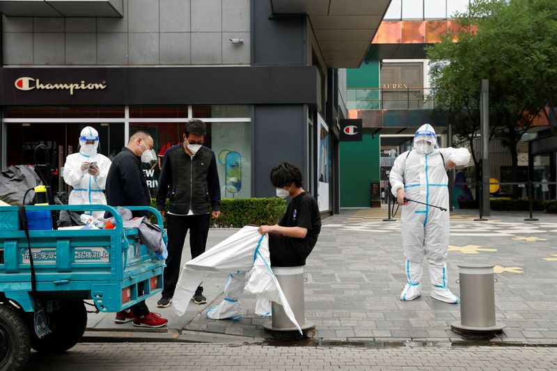 &copy; Reuters. Trabalhadores em trajes de proteção do lado de fora de complexo comercial em Pequim
13/06/2022 REUTERS/Carlos Garcia Rawlins