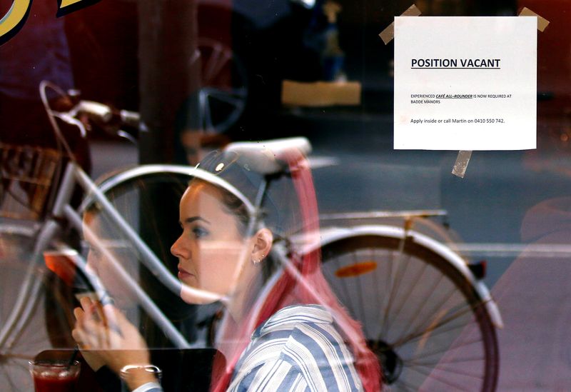 © Reuters. FILE PHOTO: Customers at a local cafe are seen through a window displaying a job vacancy notice in central Sydney, Australia, May 9, 2016. Picture taken May 9, 2016.    REUTERS/Steven Saphore