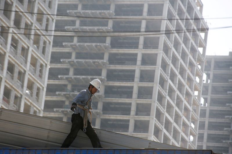 &copy; Reuters. FILE PHOTO: A man works at the construction site of a new financial district in Beijing, China May 23, 2017. REUTERS/Thomas Peter/File Photo