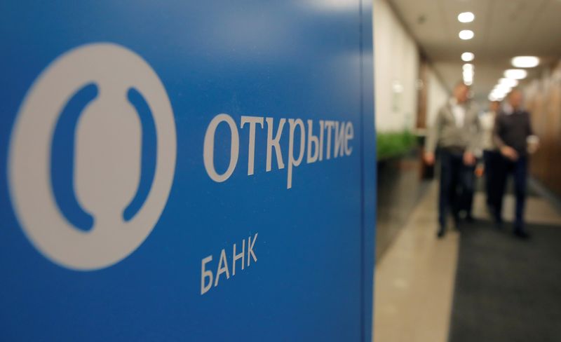 &copy; Reuters. FILE PHOTO: People walk past Otkritie Bank's logo in its office in Moscow, Russia October 30, 2018. Picture taken October 30, 2018. REUTERS/Maxim Shemetov/File Photo