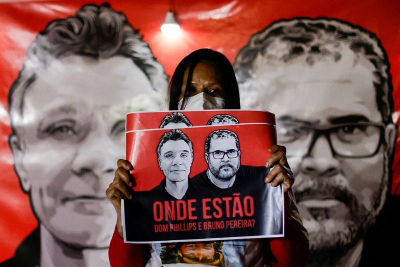 &copy; Reuters. FILE PHOTO: A demonstrator holds a sign during a protest against Brazilian President Jair Bolsonaro's government, Brazil's National Indian Foundation (FUNAI)'s President Marcelo Augusto Xavier da Silva and for the search for British journalist Dom Phillip