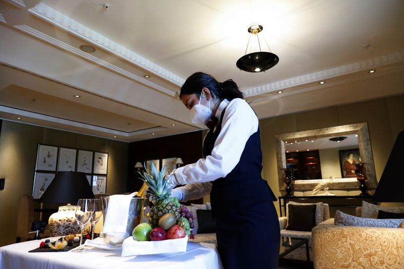 &copy; Reuters. An employee prepares to receive guests at the Hotel Adlon Kempinski after lockdown due to the coronavirus disease (COVID-19) pandemic in Berlin, Germany, June 10, 2021. Picture taken June 10, 2021. REUTERS/Michele Tantussi