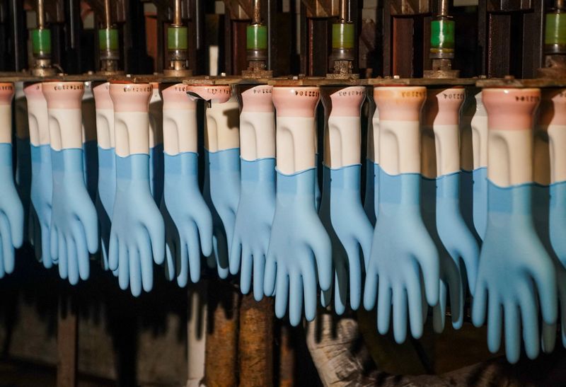 &copy; Reuters. Original nitrile glove producing machinery is pictured at a factory of SHOWA, a large Japanese glove producer, in Fayette, Alabama, U.S., June 2, 2022.  REUTERS/Marvin Gentry