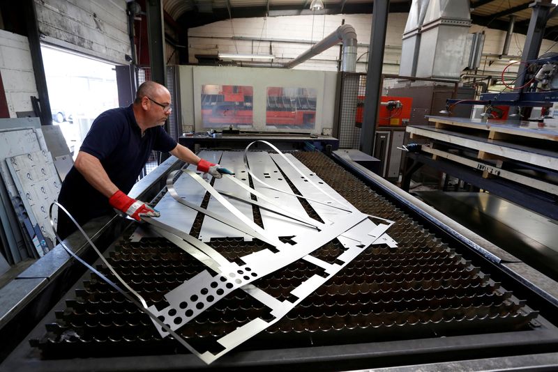 &copy; Reuters. FILE PHOTO: A laser operator removes an offcut at Contracts Engineering Ltd, a steel products manufacturer, in Sittingbourne, southeast England, Britain May 9, 2015.  REUTERS/Luke MacGregor/File Photo 