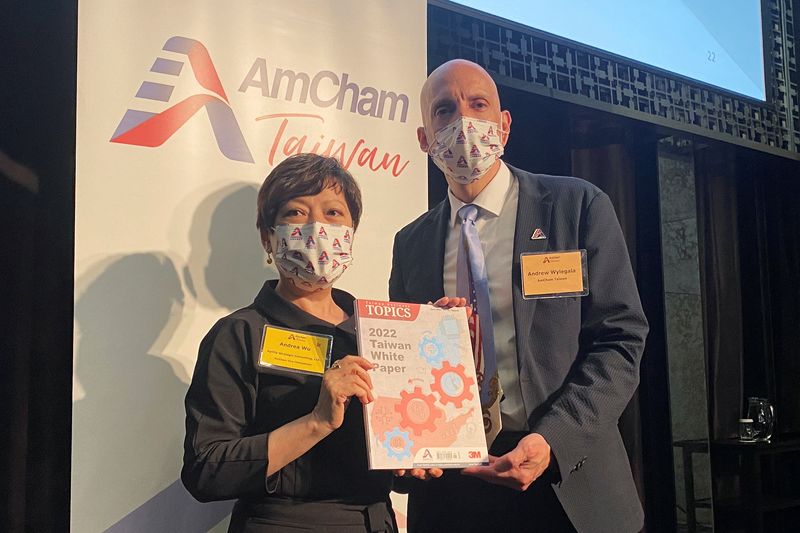 &copy; Reuters. AmCham Taiwan Vice Chairperson Andrea Wu and President Andrew Wylegala pose with a copy of the 2022 White Paper by the American Chamber of Commerce in Taiwan, in Taipei, Taiwan June 22, 2022. REUTERS/Ben Blanchard
