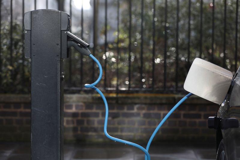 © Reuters. FILE PHOTO: A car is plugged in at a charging point for electric vehicles in London, Britain, March 6, 2018. REUTERS/Simon Dawson