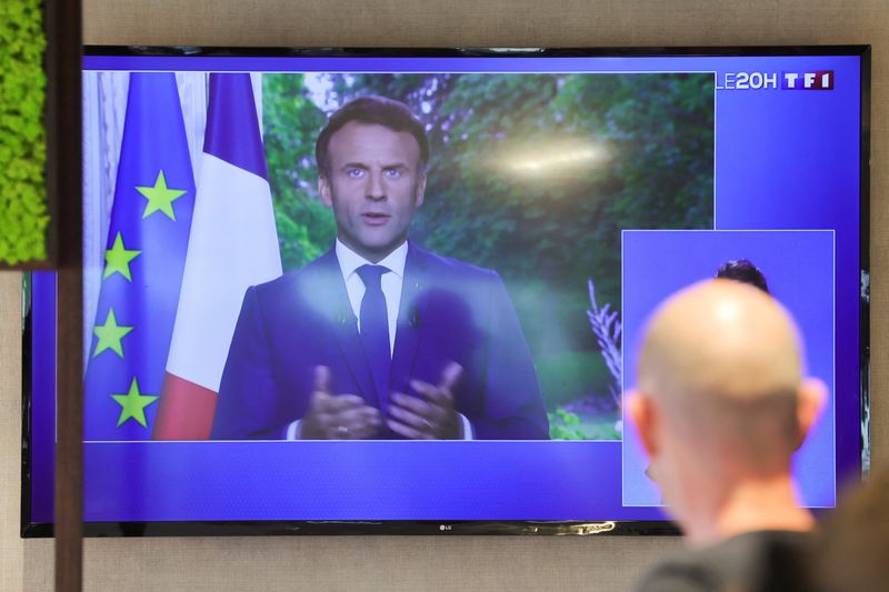 &copy; Reuters. شاشة تلفزيون تظهر الرئيس الفرنسي إيمانويل ماكرون يلقي خطابا يوم الأربعاء. تصوير: باسكال روزينول-رويترز. 