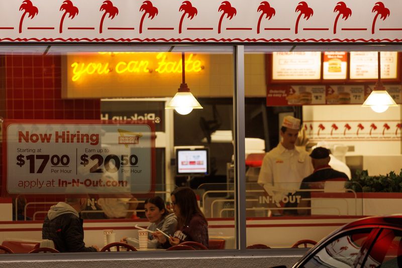&copy; Reuters. A "Now hiring" sign is displayed on the window of an IN-N-OUT fast food restaurant in Encinitas, California, U.S., May 9, 2022. REUTERS/Mike Blake