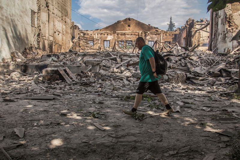 &copy; Reuters. A local resident walks in a front of a building destroyed by a military strike, as Russia's attack on Ukraine continues, in Lysychansk, Luhansk region, Ukraine June 17, 2022.  REUTERS/Oleksandr Ratushniak/Files