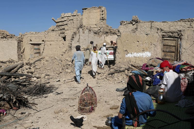 &copy; Reuters. Afghan men try to retrieve a car from the debris of damaged houses after the recent earthquake in Wor Kali village in the Barmal district of Paktika province, Afghanistan, June 25, 2022. REUTERS/Ali Khara
