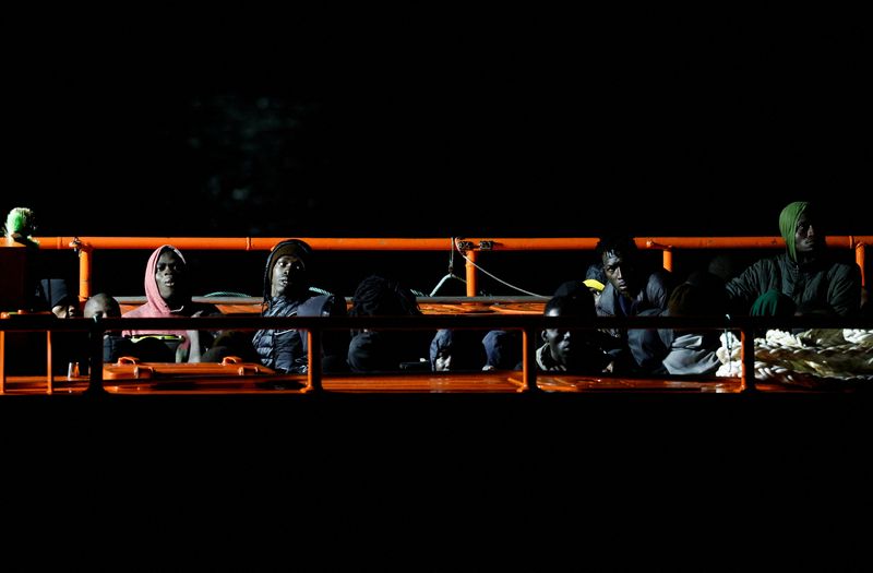 &copy; Reuters. Migrants wait to disembark from a Spanish coast guard vessel, at the port of Arguineguin, in the island of Gran Canaria, Spain, May 7, 2022. REUTERS/Borja Suarez