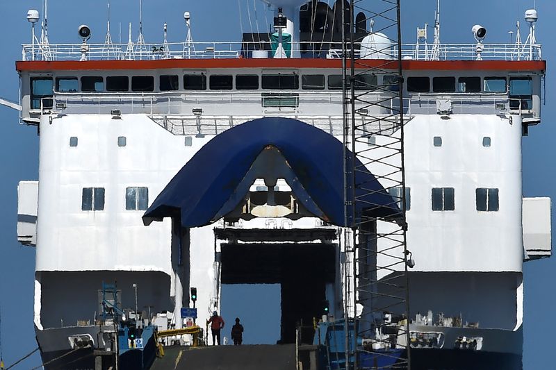 &copy; Reuters. Port workers check the empty hull of the 'European Causeway' P&O ferry bound for Scotland, before it boards freight, cars and lorries, in Larne, Northern Ireland June 20, 2022. Under the Post-Brexit Northern Ireland protocol, continued access to the Europ