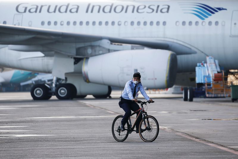 &copy; Reuters. FILE PHOTO: An aviation security officer rides a bicycle as he patrols at the Garuda Maintenance Facility (GMF) AeroAsia, at Soekarno-Hatta International airport near Jakarta, Indonesia, January 21, 2022. REUTERS/Willy Kurniawan