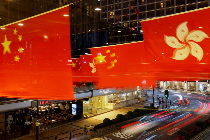 &copy; Reuters. Rows of Chinese and Hong Kong flags decorate a street outside a shopping mall, ahead of the 25th anniversary of Hong Kong's handover to China from Britain, in Hong Kong, China June 16, 2022. Picture taken June 16, 2022. REUTERS/Tyrone Siu