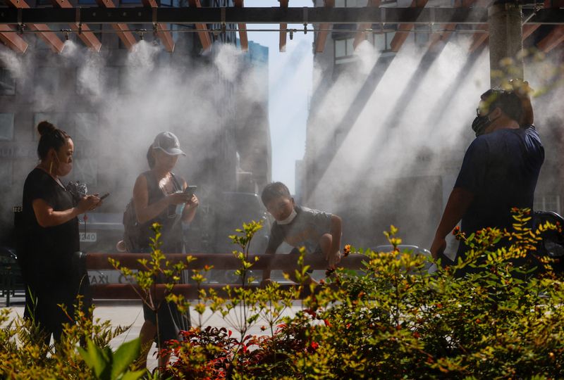 © Reuters. People take a break under a cooling mist as the Japanese government issues a warning over a possible power crunch due to a heatwave in Tokyo, Japan June 28, 2022.  REUTERS/Issei Kato