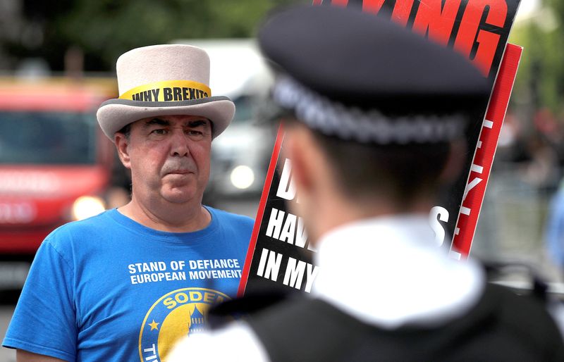 &copy; Reuters. Anti Brexit protester Steve Bray stands near a police officer after having his loudspeaker confiscated, as part of new law restricting noisy protest, in London, Britain, June 28, 2022.  REUTERS/Peter Nicholls