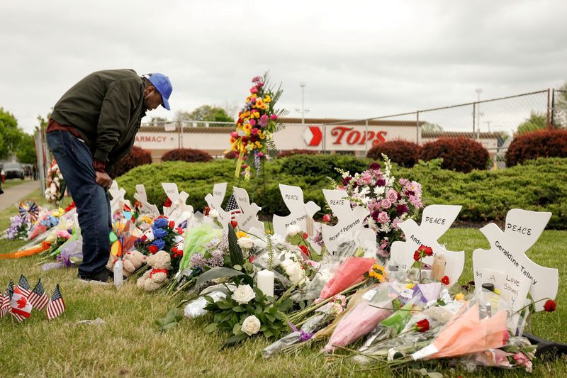 &copy; Reuters. FILE PHOTO: A man mourns at a memorial at the scene of a weekend shooting at a Tops supermarket in Buffalo, New York, U.S. May 20, 2022.  REUTERS/Lindsay DeDario