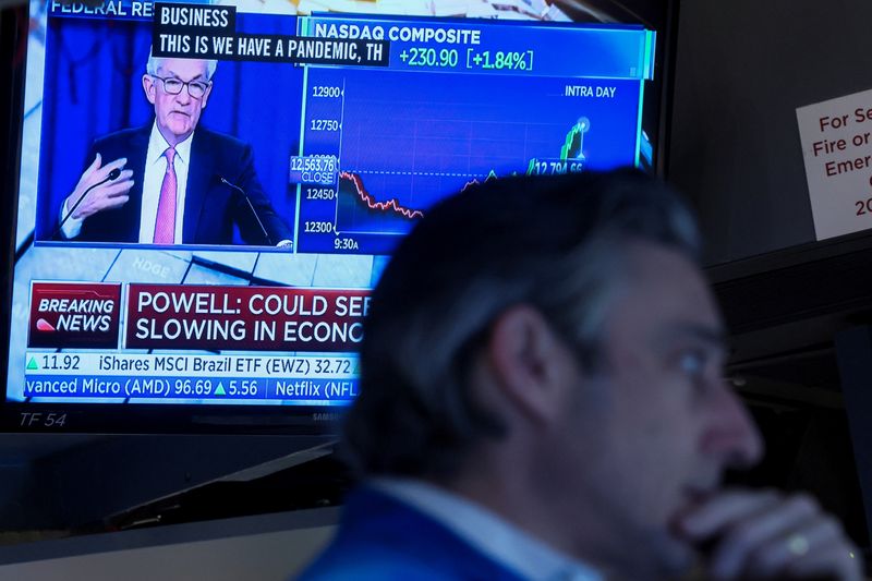 &copy; Reuters. A trader works, as Federal Reserve Chair Jerome Powell is seen delivering remarks on a screen, on the floor of the New York Stock Exchange (NYSE) in New York City, U.S. May 4, 2022. REUTERS/Brendan McDermid