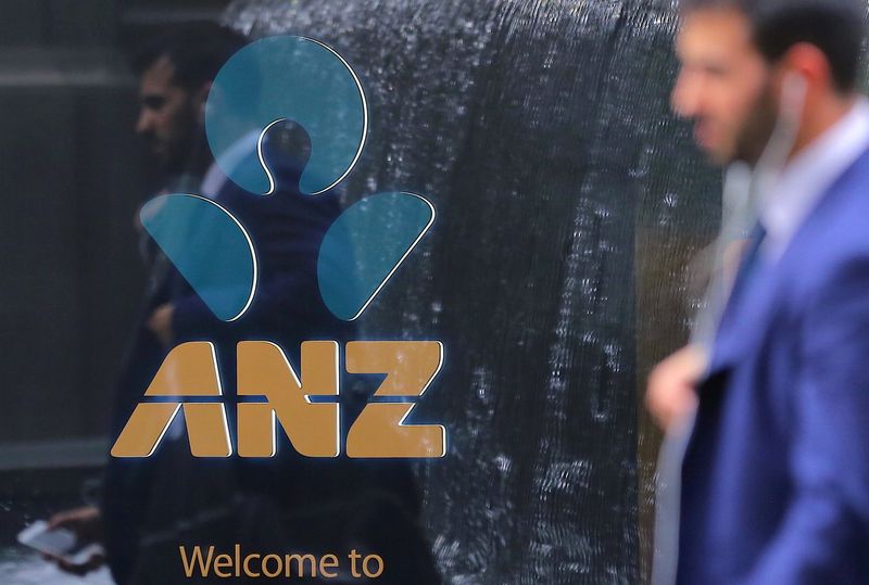 &copy; Reuters. FILE PHOTO: A pedestrian is reflected in the window of a branch of the Australia and New Zealand Banking Group (ANZ) in central Sydney, Australia, October 25, 2017.    REUTERS/Steven Saphore